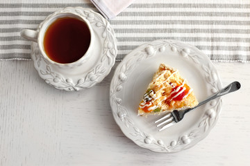 Peace of tasty Butter cake on plate, on color wooden background