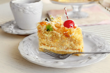 Peace of tasty Butter cake on plate, on color wooden background