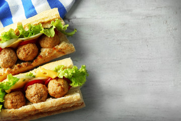 Homemade Spicy Meatball Sub Sandwich on wooden table background