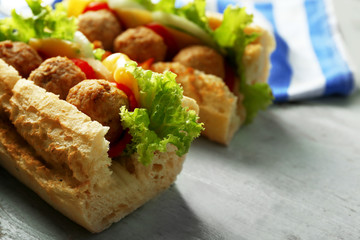 Homemade Spicy Meatball Sub Sandwich on wooden table background