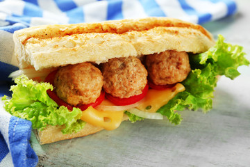 Homemade Spicy Meatball Sub Sandwich on wooden table background