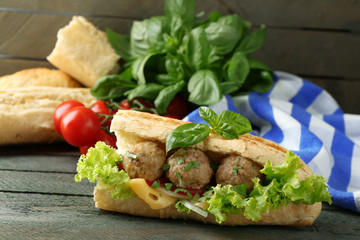 Homemade Spicy Meatball Sub Sandwich on wooden table background