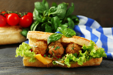 Homemade Spicy Meatball Sub Sandwich on wooden table background