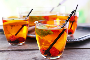 Fruity punch in glassware on metal tray, closeup