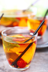 Fruity punch in glassware on metal tray, closeup