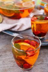 Fruity punch in glassware on metal tray, closeup
