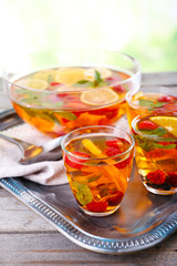 Fruity punch in glassware on metal tray, closeup