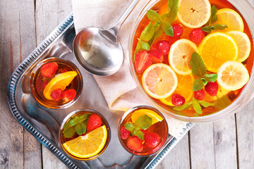 Fruity punch in glassware on metal tray, top view