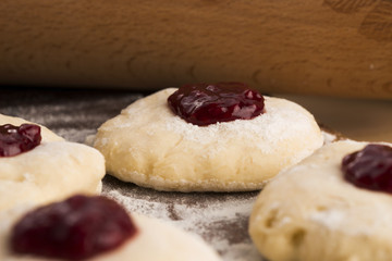 Dough with marmelade on wooden board