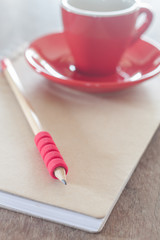 Red mug with open notebook