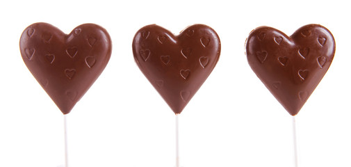Chocolate candies in shape of hearts isolated on white