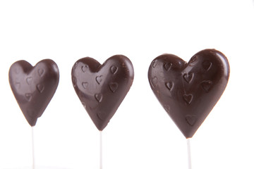 Chocolate candies in shape of hearts isolated on white