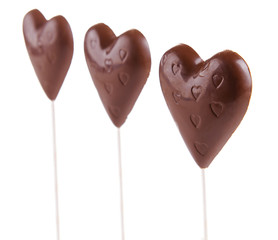 Chocolate candies in shape of hearts isolated on white