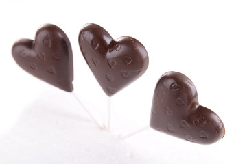 Chocolate candies in shape of hearts isolated on white