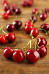 Fototapeta na wymiar Fresh cherries on wooden table, closeup