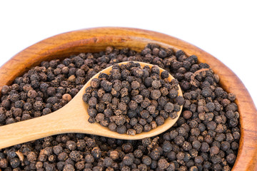 black pepper on wooden spoon with wooden plate isolated on white background.