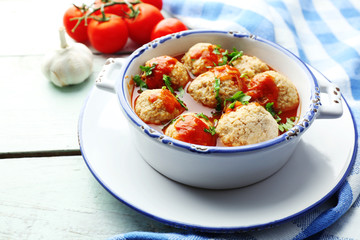 Meat balls with tomato sauce, on wooden background