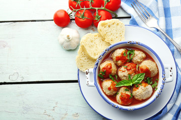 Meat balls with tomato sauce, on wooden background