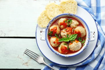 Meat balls with tomato sauce, on wooden background