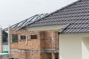 Fototapeta na wymiar black tile roof on a new house