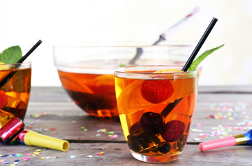 Sangria in bowl and glasses on light background