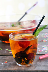 Sangria in bowl and glass on light background