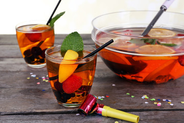 Sangria in bowl and glasses on wooden table close up