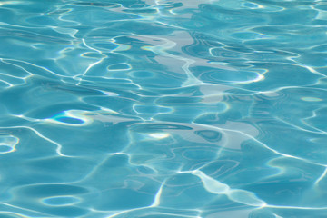 Blue pool water with sun reflections