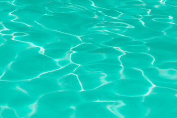 green pool water with sun reflections