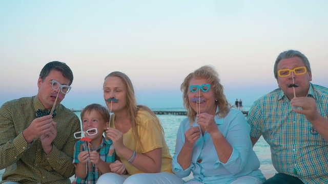 Family Playing with Flase Glasses and Moustache