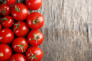 Pile of cherry tomatoes on wooden background