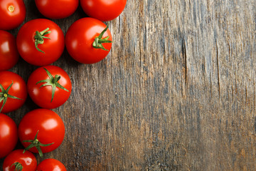 Pile of cherry tomatoes on wooden background