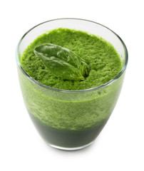 Glass of green vegetable juice with basil isolated on white