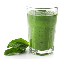 Glass of green vegetable juice with basil isolated on white
