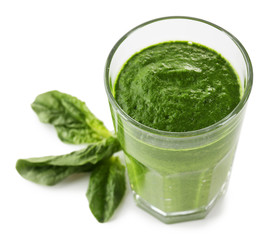 Glass of green vegetable juice with basil isolated on white