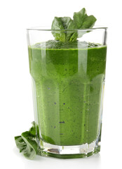 Glass of green vegetable juice with basil isolated on white