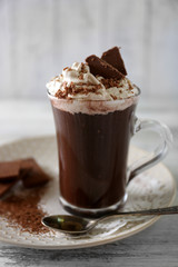 Cup of coffee with cream on color wooden background