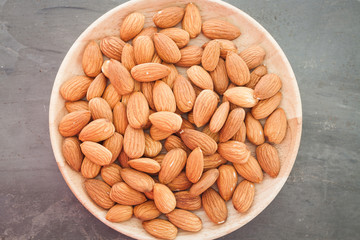 Almond nuts on wooden plate
