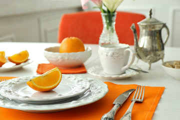 Table setting with orange napkin