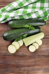 Fresh zucchini with squash and basil on wooden table close up
