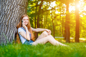 Naklejka premium Beautiful smiling red-haired young woman