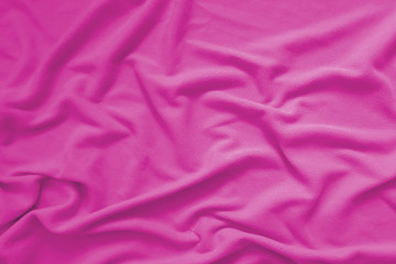 Creased pink cloth material fragment as a background
