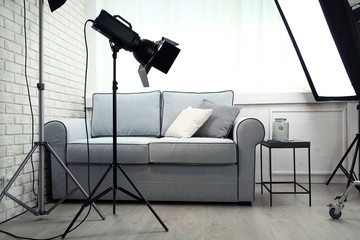 Photo studio with modern interior and lighting equipment