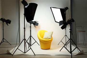 Photo studio with modern interior and lighting equipment