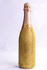 Bottle of champagne on bright background