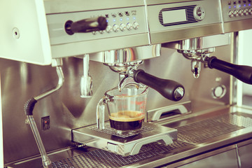Prepares espresso in coffee shop ( Filtered image processed vint