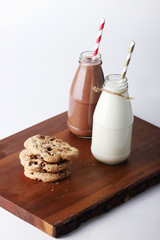 Fresh milk with drinking straw and cookies
