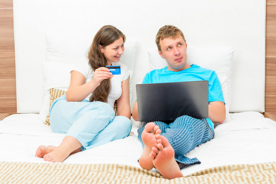 Happy couple shopping online with credit card