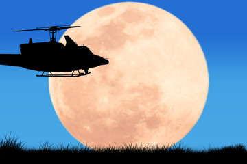 Fototapeta na wymiar silhouette of helicopter on the sky night full moon background