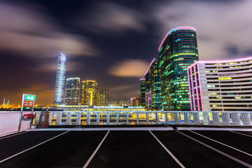 Modern city skyline and urban street at night